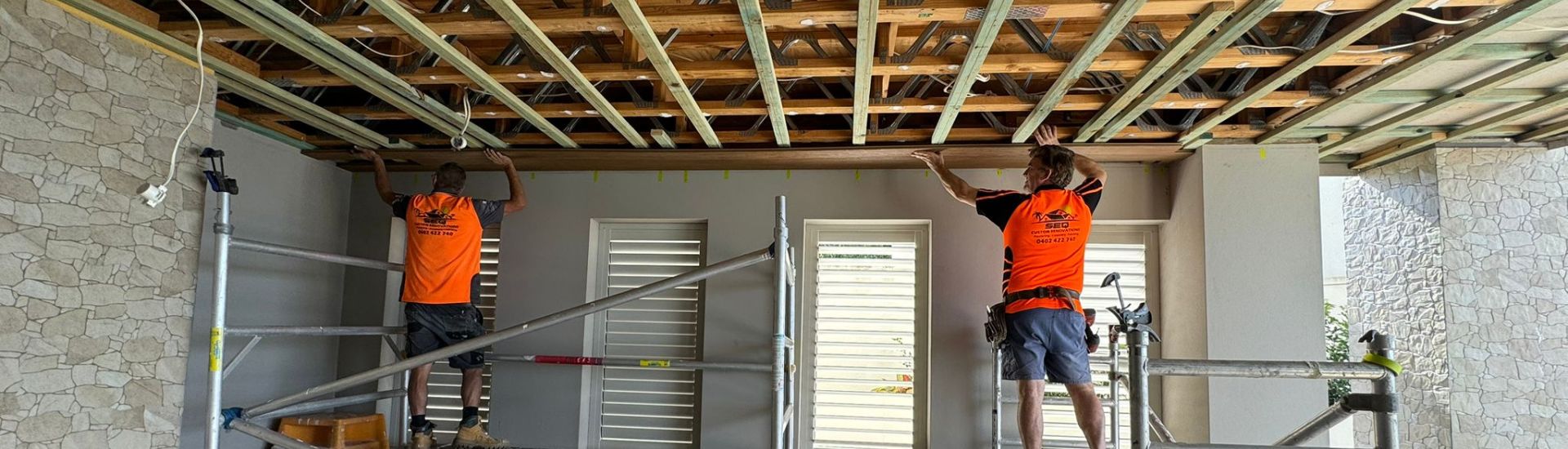 SEQ carpentry team setting out an exposed timber ceiling on scaffold