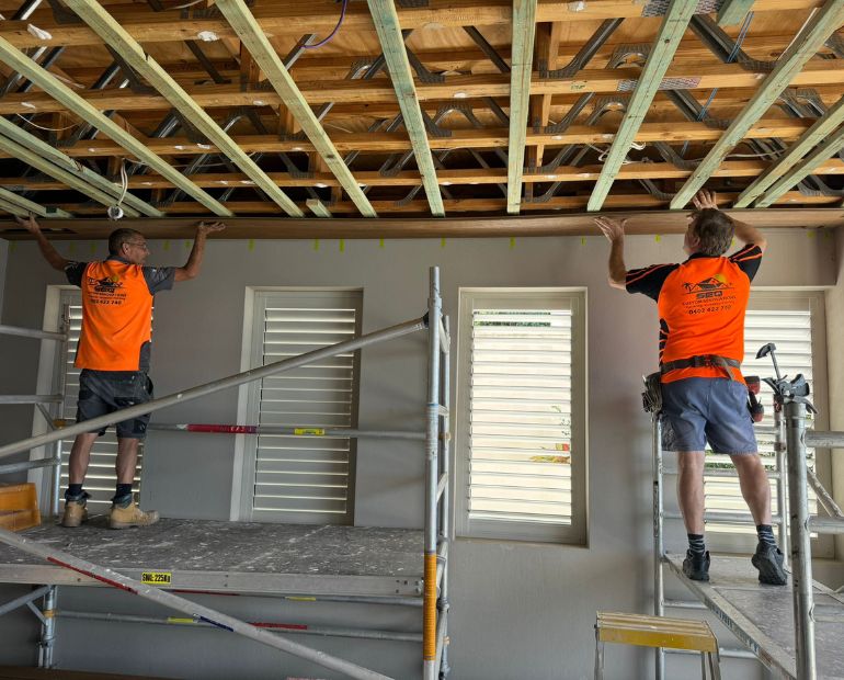 SEQ Custom Renovations carpenters fixing ceiling battens to new framing