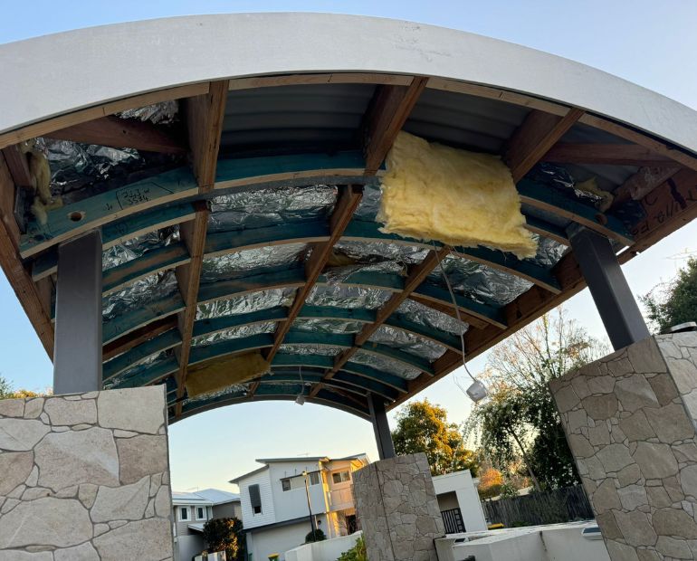 Curved awning ceiling stripped back to battens and insulation before re-sheeting