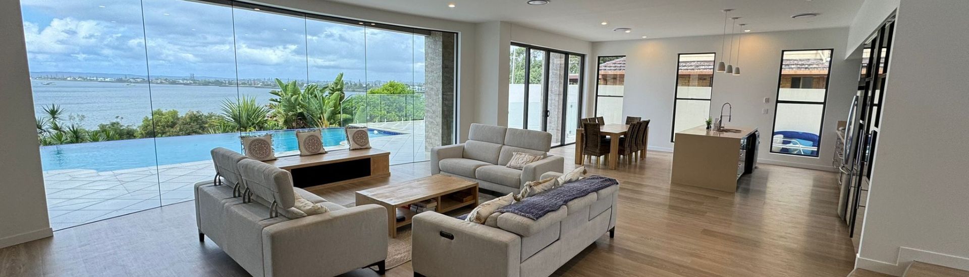 Completed waterfront home renovation with full-width glazing to the bay